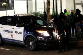 PROTESTERS BLOCK a police car after the full acquittal verdict of teenager Kyle Rittenhouse in his Wisconsin fatal shootings trial, in Portland, Oregon, US November 19, 2021. 