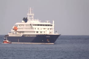 A boat beside cruise ship MV Hondius anchored off Cape Verde port, on the day sick passengers were evacuated by boat from the cruise ship, in Praia Port, Cape Verde, in this screengrab obtained from a video, May 5, 2026.