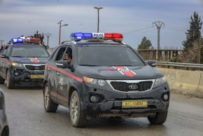 Syrian police vehicles drive along a road in the town of Dayr Hafir east of Aleppo, Syria, on January 17, 2026.