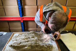 "Seeing the Dead" project member studying the burial cast of a Roman infant for traces of Tyrian purple, May 8, 2026.