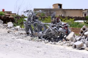 The debris of a destroyed building and a motorbike litters the ground following a Jordanian strike on reported drugs and weapons storage facilities in the village of Arman, in the southern Druze-majority province of Sweida, of which many parts are outside the control of Damascus on May 3, 2026. 