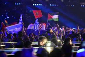 Fans display a Palestinian flag (R) during the first semi-final of the Eurovision Song Contest 2026 (ESC) at Wiener Stadthalle in Vienna, Austria on May 12, 2026.