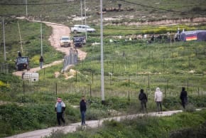 Palestinians throw stones at Jewish settlers as they establish a pastoral outpost at the site where Jewish settler Yehuda Sherman was murdered, near the village of Beit Mirin north of Nablus in the West Bank.