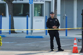A police officer stands outside the Islamic Centre of San Diego the morning following a shooting, in San Diego, California, US, May 19, 2026.