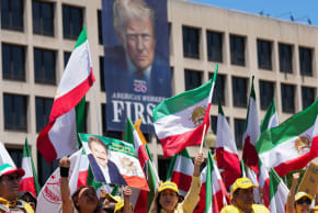 Iranian Americans and supporters of the National Council of Resistance of Iran take part in a march passing in front of the U.S Department of Labor building with a banner with the image of U.S. President Donald Trump, in Washington, DC, US, May 16, 2026.