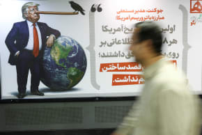 People walk past a caricature depicting US President Donald Trump, in Tehran, Iran, May 4, 2026. 