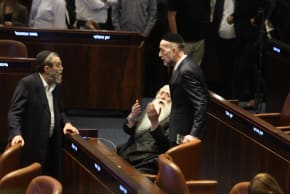 Knesset members are seen speaking with eachother as the coalition’s bill to dissolve the Knesset passed its preliminary reading on May 20, 2026 in the Knesset plenum.