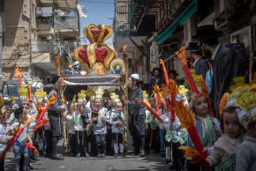 Children from the Toldot Aharon Talmud Torah march through the Mea Shearim neighborhood in Jerusalem ahead of the Shavuot holiday. May 19, 2026.