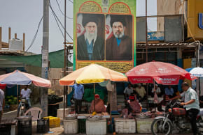 Food vendors sit below posters of the former Supreme Leader Ali Khamenei and the current Supreme Leader Mojtaba Khamenei on May 17, 2026 along the Strait of Hormuz in, on Qeshm Island, Iran. 
