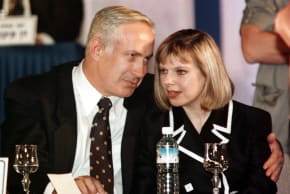 Prime Minister Benjamin Netanyahu sits with his arm around his wife Sara as she accompanies her husband on the podium during Netanyahu's election victory ceremony, on June 2, 1996.