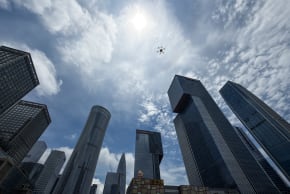 A delivery drone flies above skyscrapers in the Houhai Central Business District (CBD) in Nanshan District, China on May 22, 2026.