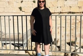 Rabbi Robin Fryer Bodzin stands in front of the Western Wall in Jerusalem. 