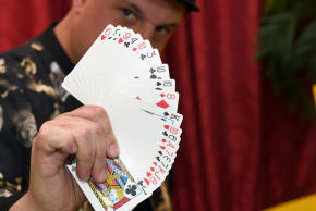 Creative director/magician Douglas "Lefty" Leferovich fans out a deck of cards before teaching magic tricks on Facebook Live with magician/comedian Murray SawChuck from SawChuck's home to entertain people under stay-at-home orders to fight the spread of the coronavirus on April 25, 2020 in Las Vegas