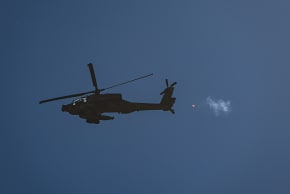 An Israeli military helicopter is seen flying above the Israel-Lebanon border during an Israeli military operation, June 4, 2026.