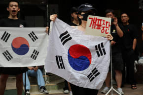 Far-right protesters chant slogans, calling for a halt to vote counting and a rerun of the race, as they surround a polling station where ballot boxes for local elections are still kept in, in Seoul, South Korea, June 4, 2026.