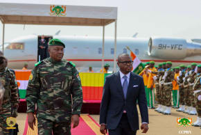 The head of the Nigerien junta, General Abdourahamane Tiani, walks with Beninese President Romuald Wadagni during his arrival for the first leg of a visit to Niger and Burkina Faso, at the Diori Hamani International Airport in Niamey, Niger June 2, 2026.