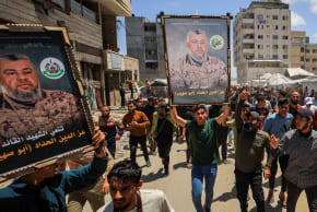 Mourners carry images of Hamas' military wing commander Izz al-Din al-Haddad during a funeral, in Gaza City, May 16, 2026.