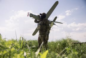 A member of the Lava Unmanned Systems Regiment, Norman, poses for a photograph with a Bulava strike drone, a kamikaze UAV capable of carrying a 3.5-kilogram payload with a range of up to 100 kilometers in Kharkiv region, Ukraine.