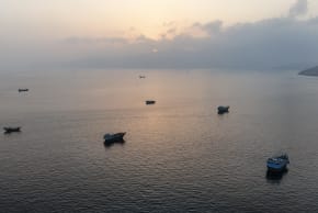 This aerial photograph shows boats anchored off Oman's northern Musandam Peninsula near the Strait of Hormuz on June 27, 2026.