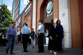 Police liaison officers stand guard outside the East London Mosque in Tower Hamlets, London on August 9, 2024. 