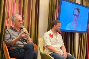 Avi Nesher, Emilio Schenker, and Danny Cohen (on the screen) spoke at a panel on Israeli film at the Jerusalem Film Festival.