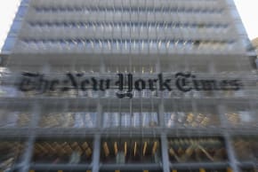The New York Times logo is seen on the building's facade in New York City on January 22, 2026. US President Donald Trump announced today he will sue The New York Times over an unfavorable opinion poll and suggested that what he called "fake" surveys should criminalized.