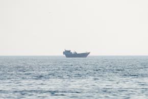 A vessel at the Strait of Hormuz, as seen from Musandam, Oman, July 23, 2026. 