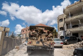 Lebanese army officers on a military vehicle drive in Zawtar al-Gharbiyeh, a village in southern Lebanon, following the deployment of Lebanese soldiers in one of three pilot zones after the withdrawal of Israeli forces under a US-brokered plan, July 26, 2026. 