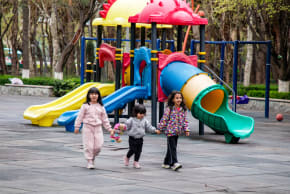 Children are seen at a playground.