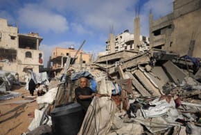 (FILE PHOTO) A Palestinian man inspects the site of Wednesday's Israeli strike on a house whose residents were pre-warned by the Israeli military to evacuate, in Gaza City, July 30, 2026.