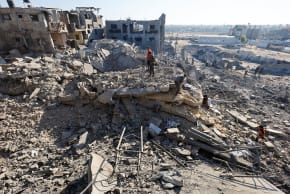 Palestinians inspect a site of an Israeli strike on a house that was pre-warned by the Israeli military to evacuate on Saturday before the strike was carried out later that day, in Deir Al-Balah, central Gaza Strip, July 19, 2026. 