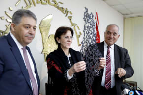 Palestinian Ambassador to Lebanon Ashraf Dabbour (L) stands next to U.N. Under-Secretary General and ESCWA Executive Secretary Rima Khalaf (C) while she holds a gift, an Arabic calligraphy that reads "All the world is Palestine."