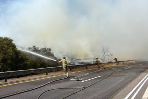 Firefighters work to contain a fire on Highway 6 on August 4, 2026. 