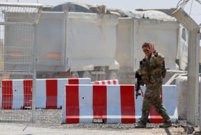 A US soldier waves at the entrance to the LSA Endurance, a logistical support and staging facility designed to support the International Stabilization Force (ISF) under the direction of the Board of Peace (BoP), near the aza border in the Kerem Shalom area, southern Israel, August 10, 2026