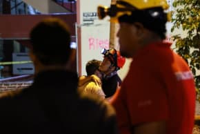 A man cries as he embraces a rescue worker in the aftermath of an earthquake, in Cali, Colombia, August 13, 2026. 