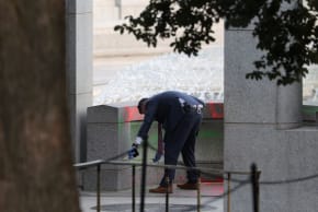 An investigator works at the World War II Memorial, after the pool was reportedly vandalized with soap and graffiti in Washington, DC, US, August 13, 2026. 