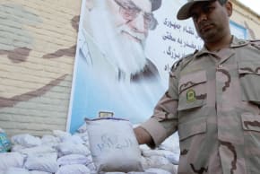 An Iranian policeman holds up a package of seized Afghan-made drugs during a media tour in the southeastern city of Zahedan, on July 19, 2011; illustrative