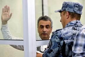 A bailiff puts handcuffs on Russian opposition politician Lev Shlosberg, sentenced to 11 years in prison over his criticism of Moscow's offensive in Ukraine at a city court in Pskov, northwestern Russia on August 17, 2026. 