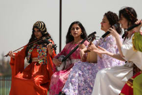 Artists perform, as Kurdish female fighters attend a military parade to mark the 13th anniversary of the founding of the Women's Protection Units (YPJ) in Qamishli, Syria, April 4, 2026.