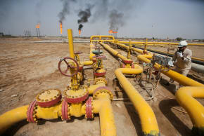 A worker checks an oil pipeline at Nahr Bin Umar oil field, north of Basra, Iraq.
