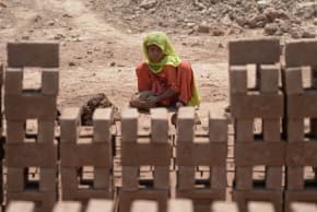 Pakistani girl helps make bricks at a kiln during World Day Against Child Labour on the outskirts of Islamabad on June 12, 2014. 