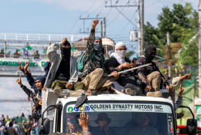 Supporters of a political group cheer after destroying a vehicle believed to contain firearms during the first parliamentary elections of the Bangsamoro Autonomous Region in Muslim Mindanao (BARMM), outside Sero Central Elementary School, Cotabato City, Philippines, September 14, 2026.