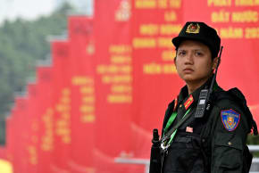 A police officer stands in front of posters for the 14th Congress of the Communist Party of Vietnam outside the National Convention Center in Hanoi on January 19, 2026. 