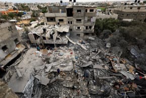 Palestinians inspect the site of a house targeted by airstrikes after the Israeli military warned residents to evacuate late on Saturday, in Al-Zawayda, central Gaza Strip, October 11, 2026.