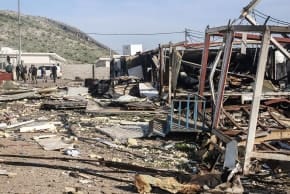 Illustrative: Komala party members look towards the debris is strewn from mangled structures following drone strikes on the Iranian Kurdish opposition Komala party's Sordash camp, which resulted in the death of a female party member and the injury of two others, April 15, 2026.
