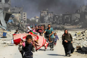 Displaced Palestinians make their way after fleeing the northern part of Gaza amid an Israeli military operation, in Gaza City.