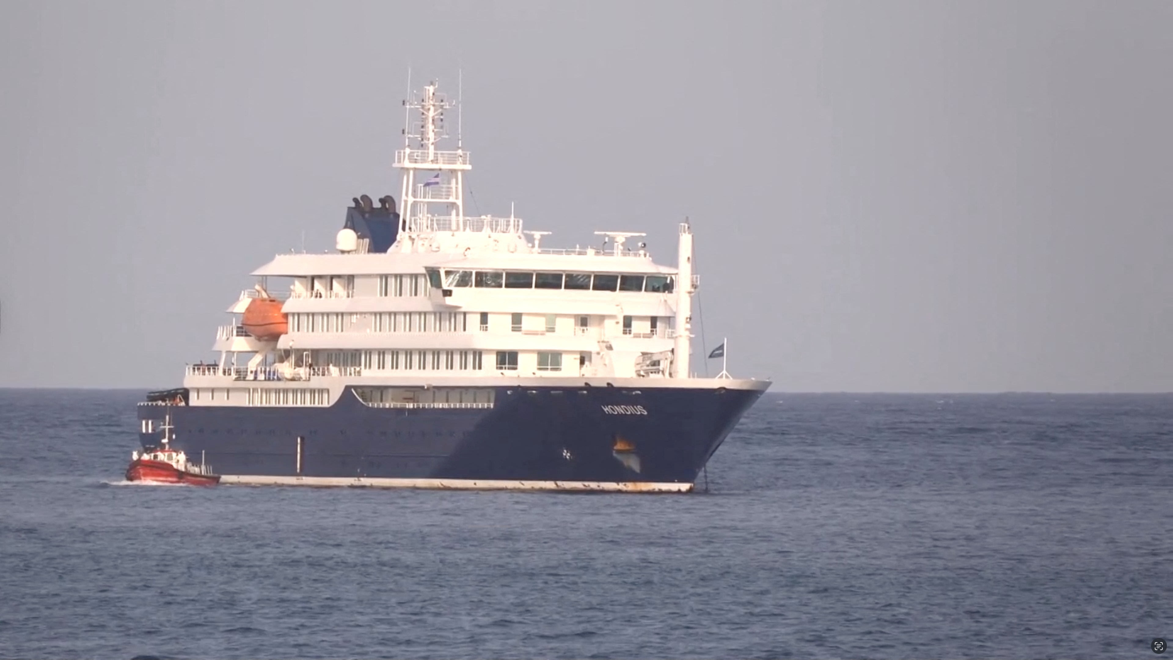 A boat beside cruise ship MV Hondius anchored off Cape Verde port, on the day sick passengers were evacuated by boat from the cruise ship, in Praia Port, Cape Verde, in this screengrab obtained from a video, May 5, 2026. (photo credit: REUTERS TV via REUTERS)