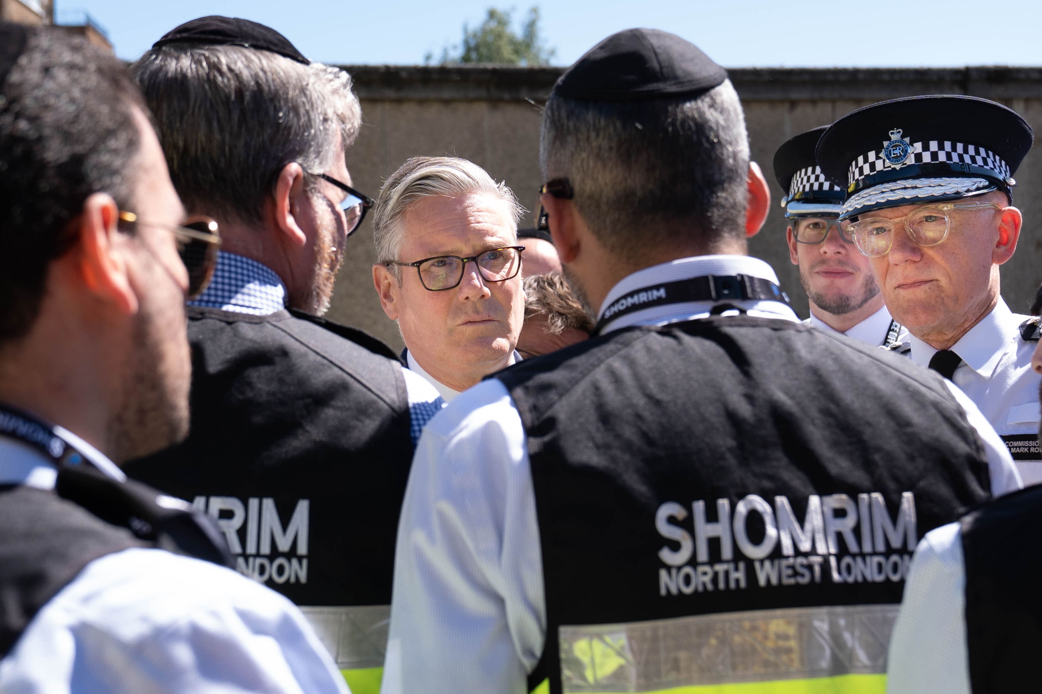 Prime Minister Sir Keir Starmer (C) and Metropolitan Police Commissioner Sir Mark Rowley (2nd R) meet first responders from Shomrim North West London during a visit to Golders Green on April 30, 2026 in Golders Green, England. (photo credit: Stefan Rousseau - WPA Pool/Getty Images)