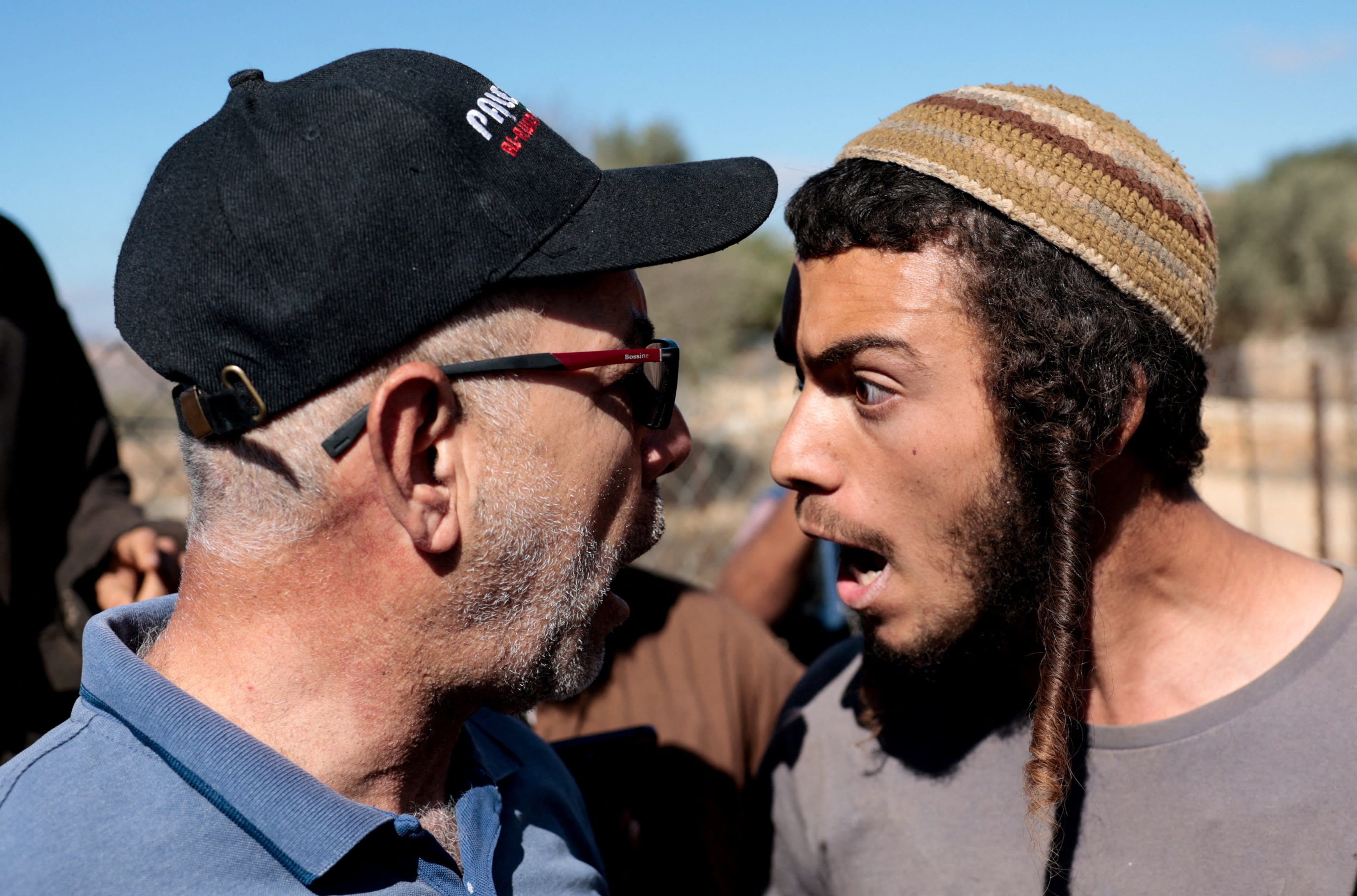 An Israeli settler argues with a Palestinian farmer, during olive harvesting in Silwad, near Ramallah, October 29, 2025. (photo credit: REUTERS/Mohammed Torokman TPX IMAGES OF THE DAY)