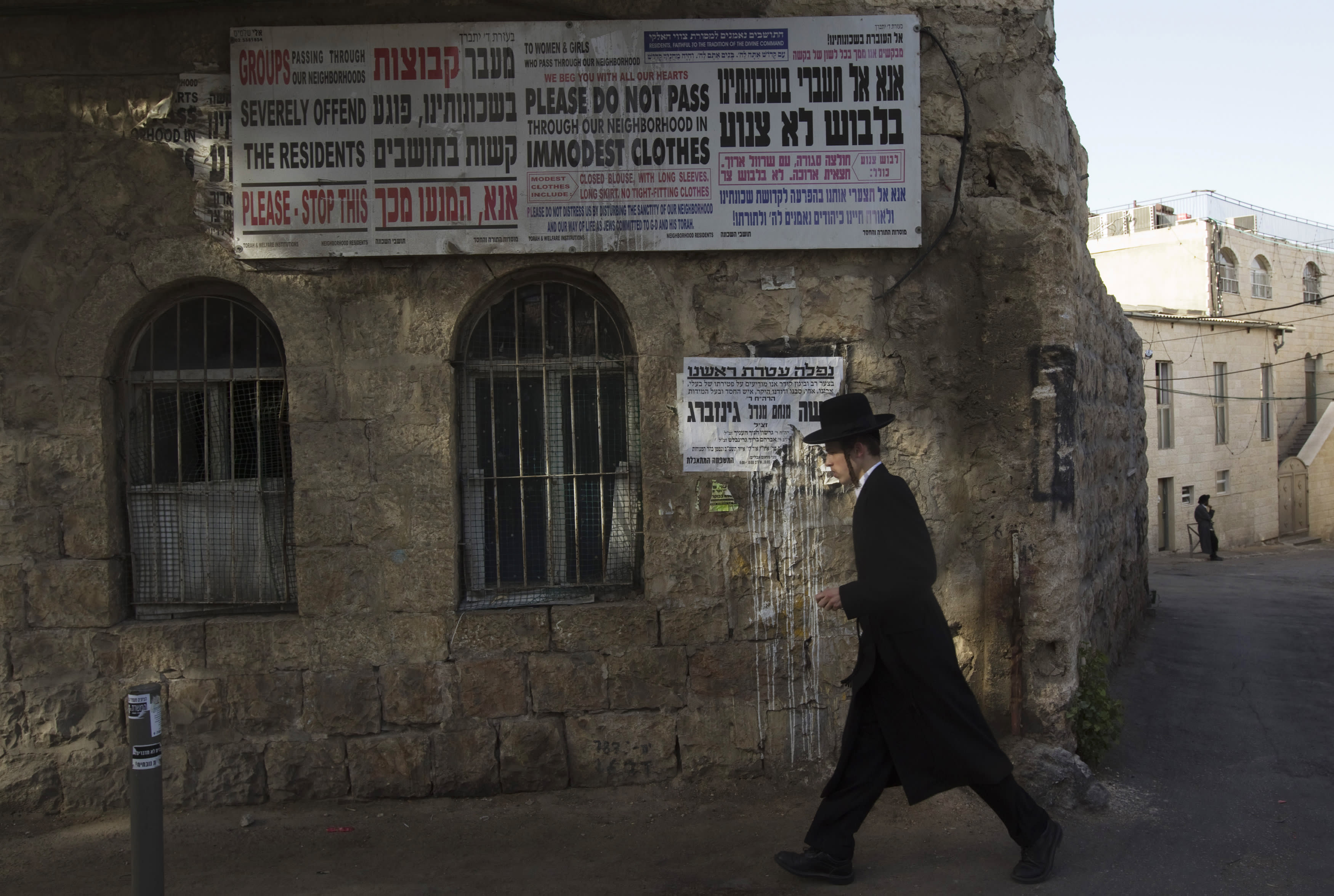 n ultra-Orthodox Jew walks on a street in Jerusalem